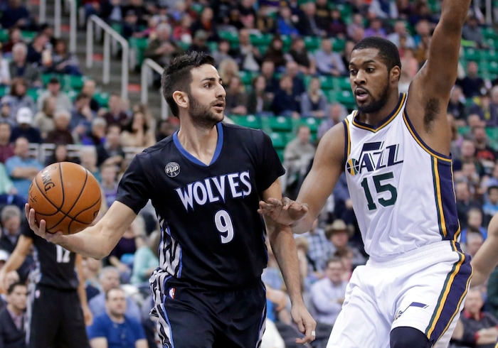 Minnesota Timberwolves guard Ricky Rubio (9) passes the ball as Utah Jazz forward Derrick Favors (15) defends during the first quarter in an NBA basketball game Friday, Jan. 29, 2016, in Salt Lake City. (AP Photo/Rick Bowmer)