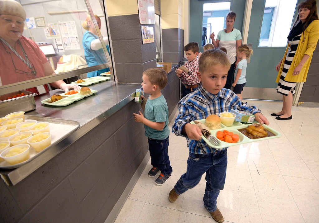 (Al Hartmann  |  The Salt Lake Tribune) Children line up for lunch during their school day in Park Valley, Utah, in 2017. Funding for school breakfast and lunch programs has been extended into at least March as the government shutdown continues.