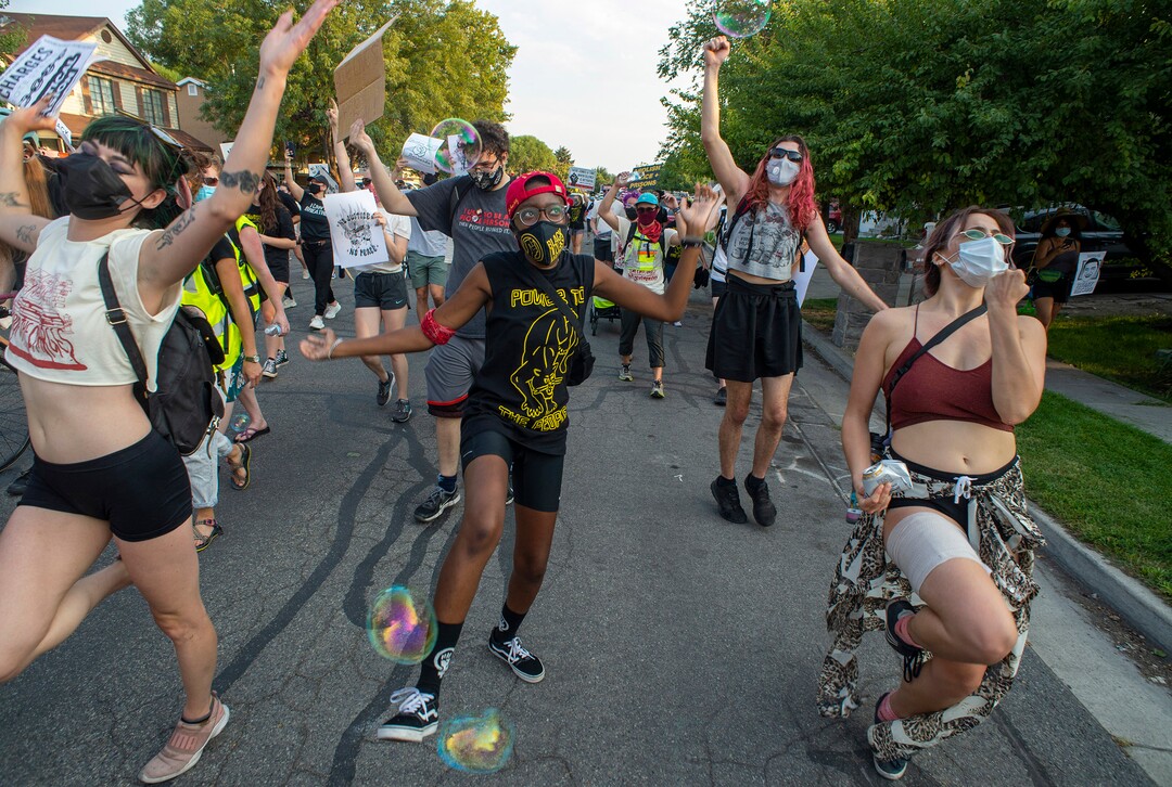 (Rick Egan  |  The Salt Lake Tribune)     Protesters dance through the neighborhood in Rose Park, during the Dance Dance for Revolution protest for racial equality, on Sunday, Aug. 23, 2020. The protest was in memory of Jovany Mercardo who was shot last August by Ogden police by four officers, hitting his body sixteen times.