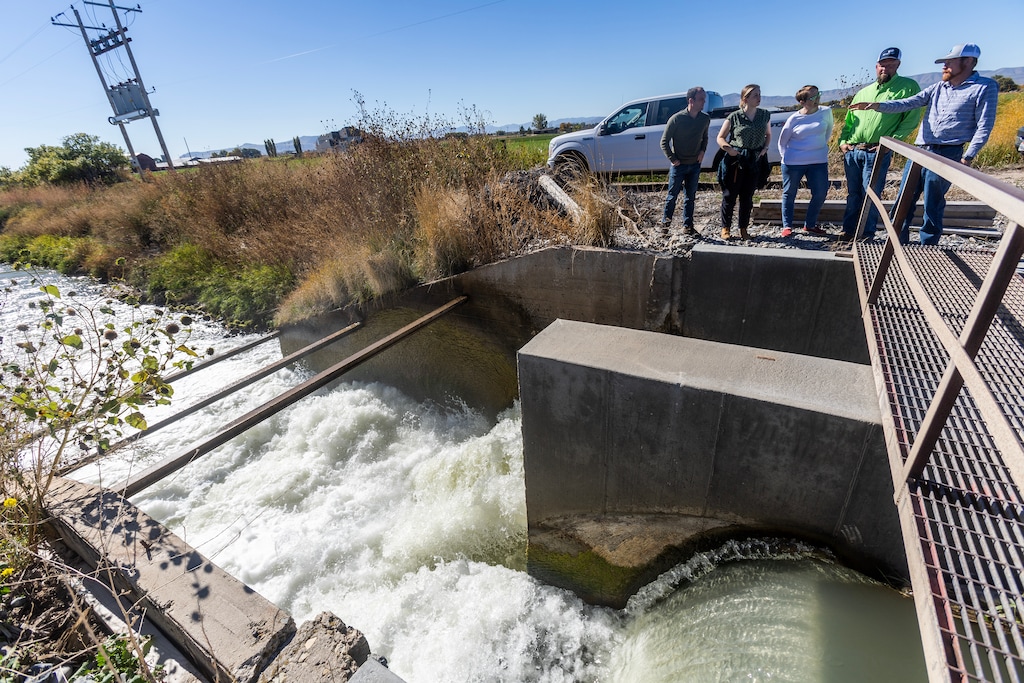 (Brian Nicholson | Special to the Standard-Examiner) Trevor Nielson, right, of the Bear River Canal Co. talks about the new high tech gates and other issues with water officials during a tour of various canal sites in Box Elder County Thursday, Oct. 19, 2023.