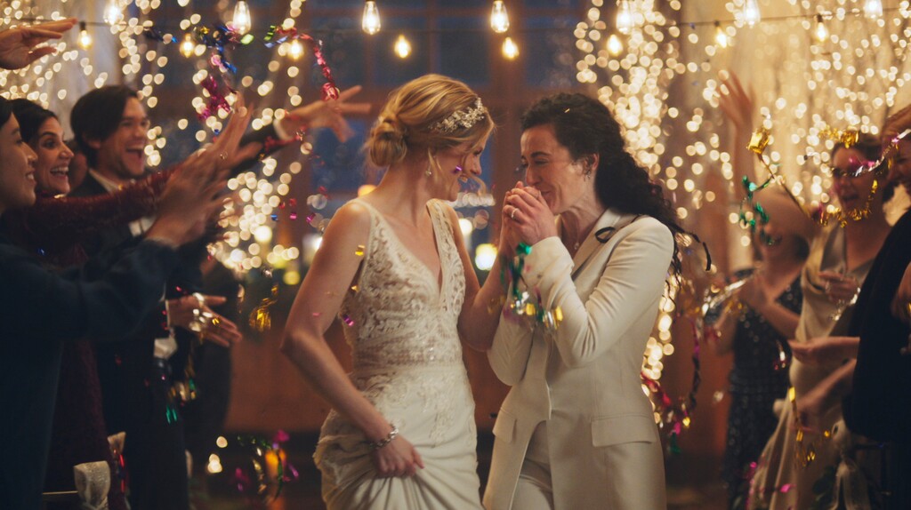 (Zola via AP) This image made from undated video provided by Zola shows a scene of its advertisement. The Hallmark Channel says it will reinstate same-sex marriage commercials that it had pulled from the network. Hallmark Cards CEO Mike Perry said in a statement Sunday, Dec. 15, 2019, that pulling the commercials “was the wrong decision."
