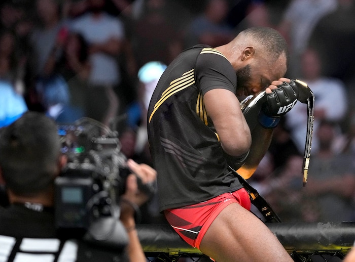 (Francisco Kjolseth | The Salt Lake Tribune) UFC fighter Leon Edwards, of Jamaica, celebrates his title from the fence of the octagon as welterweight champion of the world after knocking out Nigerian UFC fighter Kamaru Usman during the UFC 278 mixed martial arts title bout in Salt Lake City on Saturday, Aug. 20, 2022.