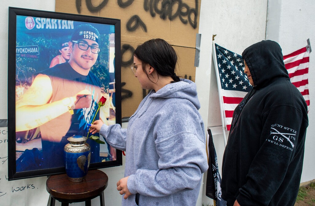 (Rick Egan | The Salt Lake Tribune) Olivia Herrera and Bryan's son, Luciano Pena-Valencia place a flower on the memorial for Bryan Pena-Valencia on Saturday, March 20, 2021. 