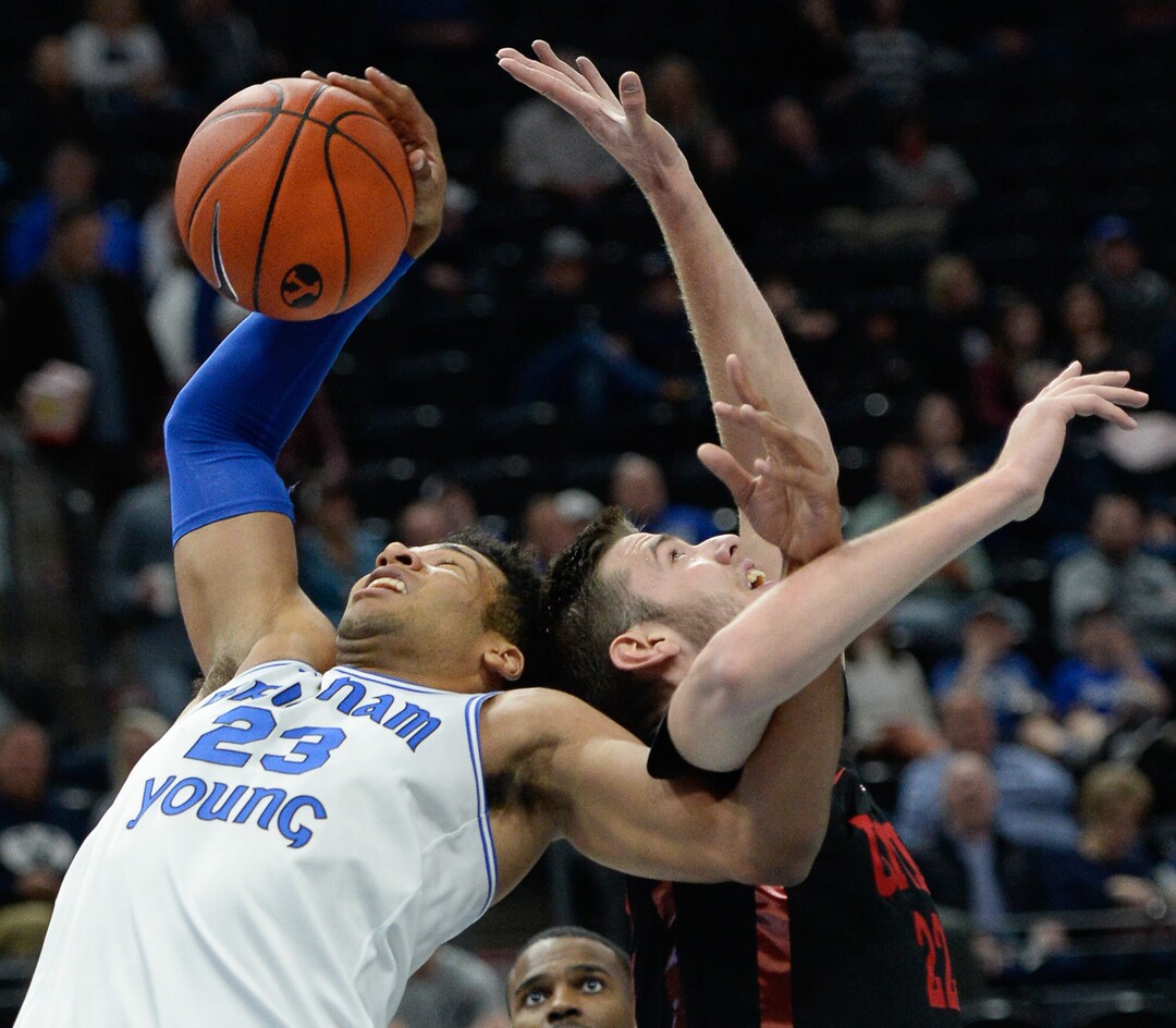 (Francisco Kjolseth  |  The Salt Lake Tribune)  Brigham Young Cougars forward Yoeli Childs (23) gets tangled with UNLV Rebels forward Vitaliy Shibel (22) as BYU takes on UNLV in men's NCAA basketball at Vivint Smart Home Arena in Salt Lake City on Sat. Dec. 7, 2019.