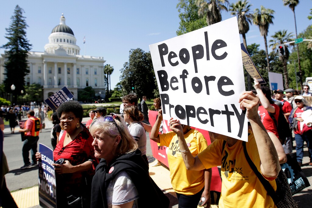 FILE - In this April 23, 2018, file photo, supporters of a rent control initiative march near the state Capitol calling for more rent control, in Sacramento, Calif. State regulators are investigating a claim by supporters of a ballot proposal to let cities expand rent control that opponents have accepted improper campaign donations. The allegations will be reviewed by the enforcement division of the Fair Political Practices Commission, which said it had made no decision about the validity of the claims. (AP Photo/Rich Pedroncelli, File)