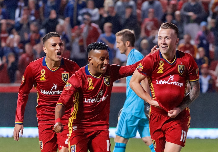 (Michael Mangum  |  Special to the Tribune)  Real Salt Lake midfielder Albert Rusnak (11), right, tucks the ball under his jersey as he celebrates his first half goal with teammates Joao Plata (10), center, and Luis Silva as Portland Timbers goalkeeper Jeff Attinella walks away from the goal during their MLS match at Rio Tinto Stadium in Sandy, UT on Saturday, September 16, 2017.