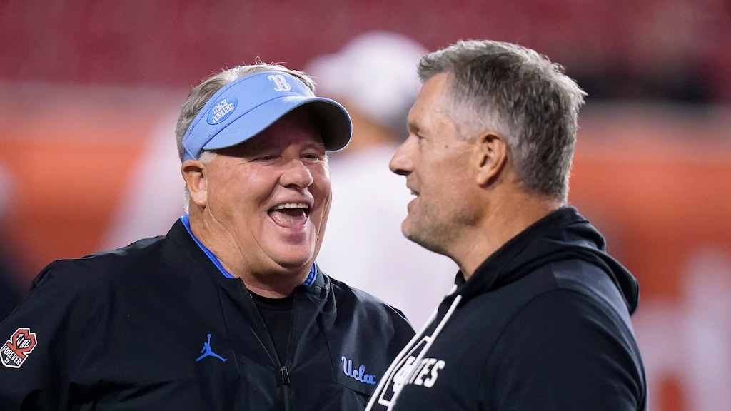 (Rick Bowmer | AP) UCLA coach Chip Kelly, left, and Utah coach Kyle Whittingham laugh before an NCAA college football game Saturday, Oct. 30, 2021, in Salt Lake City.