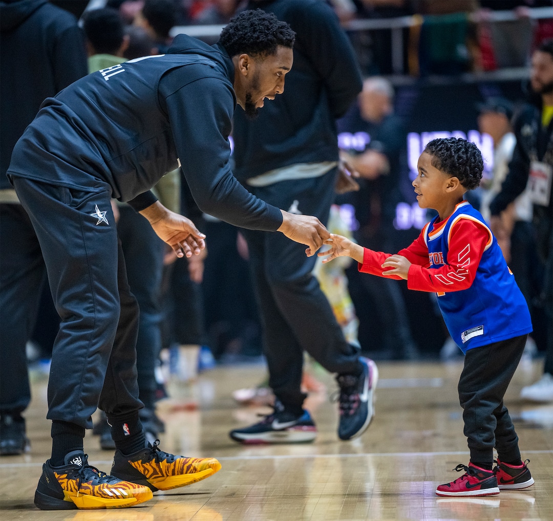 (Rick Egan | The Salt Lake Tribune) Donovan Mitchell jokes with 4-year-old Zakai Bryant, during the All-Star Practice at the Jon M. Huntsman Center, on Saturday, Feb. 18, 2023.