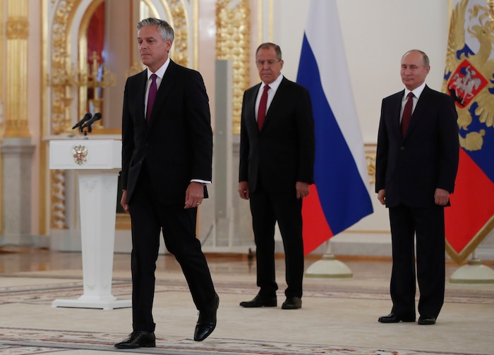 U.S. ambassador Jon Huntsman, left, after presenting credentials to Russian President Vladimir Putin, right, during a ceremony in the Kremlin in Moscow, Russia, on Tuesday, Oct. 3, 2017. The new U.S. ambassador to Russia presented his credentials to President Vladimir Putin in the Kremlin  amid investigations into Moscow's meddling in the 2016 U.S. elections. Russian Foreign Minister Sergey Lavrov is seen in the center. (AP Photo/Pavel Golovkin, pool)