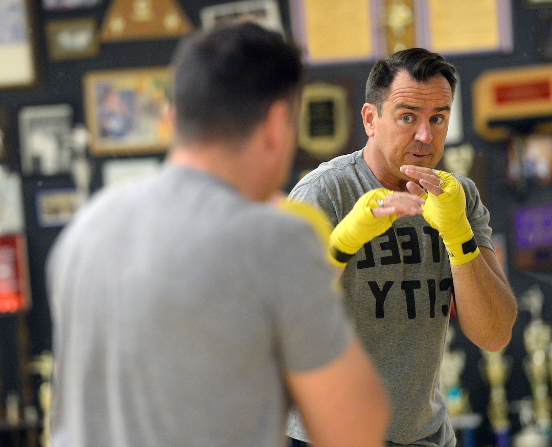 (Al Hartmann  |  The Salt Lake Tribune) House Speaker Greg Hughes works on his boxing form in the mirror during a workout at the Flash Academy gym in Holladay Tuesday August 29.  He's among a handful of local politicians, police and lobbyists who will box in a series of charity matches to benefit a national group that works to end domestic violence.
