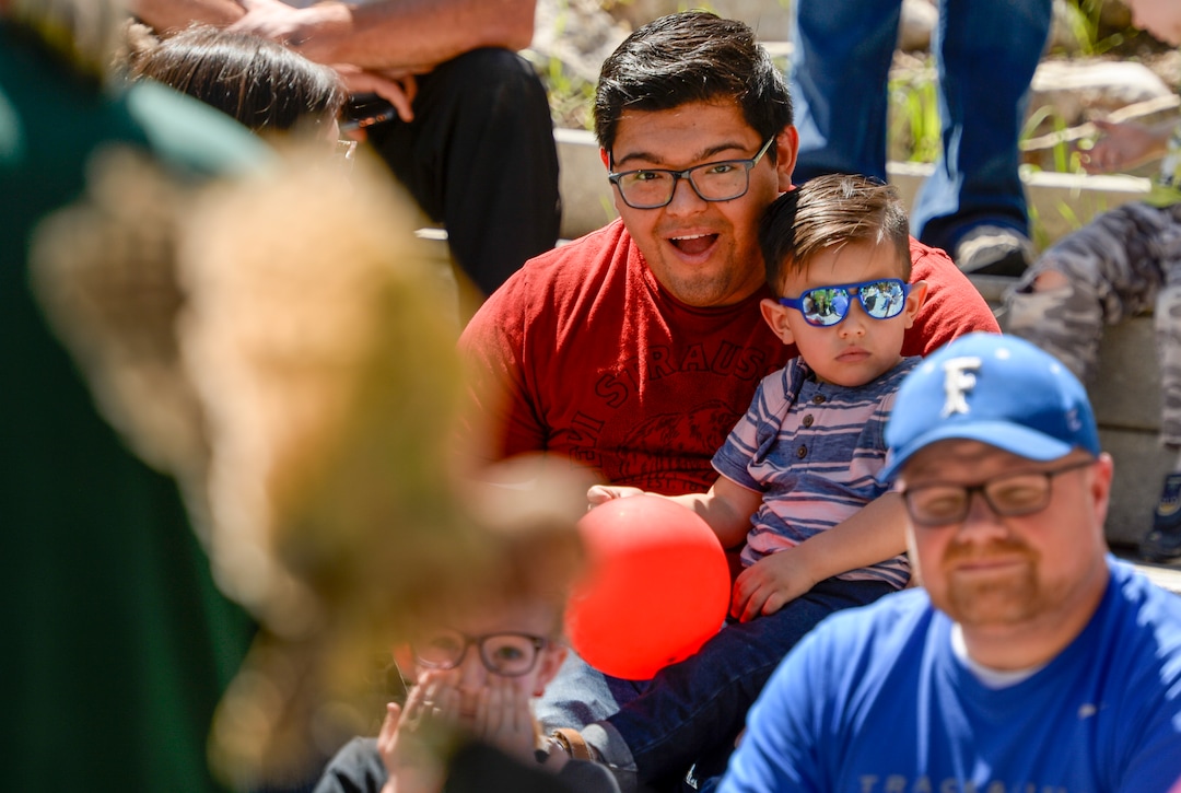Leah Hogsten  |  The Salt Lake Tribune  Ricardo Paez, holding his son Izan, 2, watches a burrowing owl flap its wings as the two learn all about owls including barn, screeh, great horned owls during Earth Day celebration at the Ogden Nature Center, Saturday, April 20, 2019. 