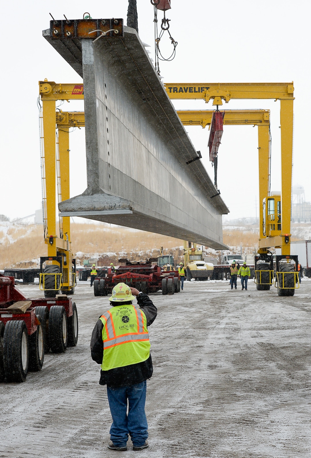 (Francisco Kjolseth  |  The Salt Lake Tribune)  UDOT gets ready to place some of the world's largest-ever bridge beams, and the largest in Utah state history with a span of 203 ft long and just over 8 ft tall, as crews load one on a truck following manufacturing at Forterra Structural Precast in Kearns on Tuesday, Dec. 11, 2018. A total of six beams will be installed in the technology corridor in Lehi later this week.