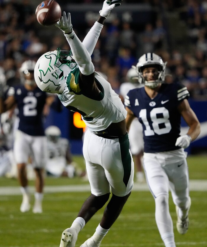 (Francisco Kjolseth | The Salt Lake Tribune) South Florida Bulls defensive back TJ Robinson (2) tries to pull in a pass intended for Brigham Young Cougars wide receiver Gunner Romney (18) in game action between the Brigham Young Cougars and the South Florida Bulls at LaVell Edwards Stadium in Provo, Saturday, Sept. 25, 2021.