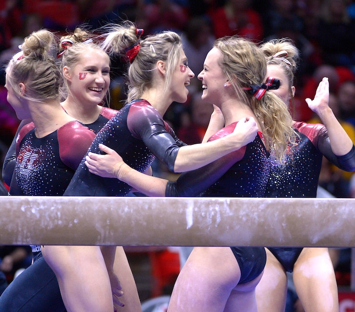 Leah Hogsten  |  The Salt Lake TribuneThe team celebrates with Maddy Stover after her routine on the beam. University of Utah gymnastics fans got their first glimpse of this yearÕs team at the Red Rocks Preview intrasquad meet at the Huntsman Center, Friday, December 9, 2016.