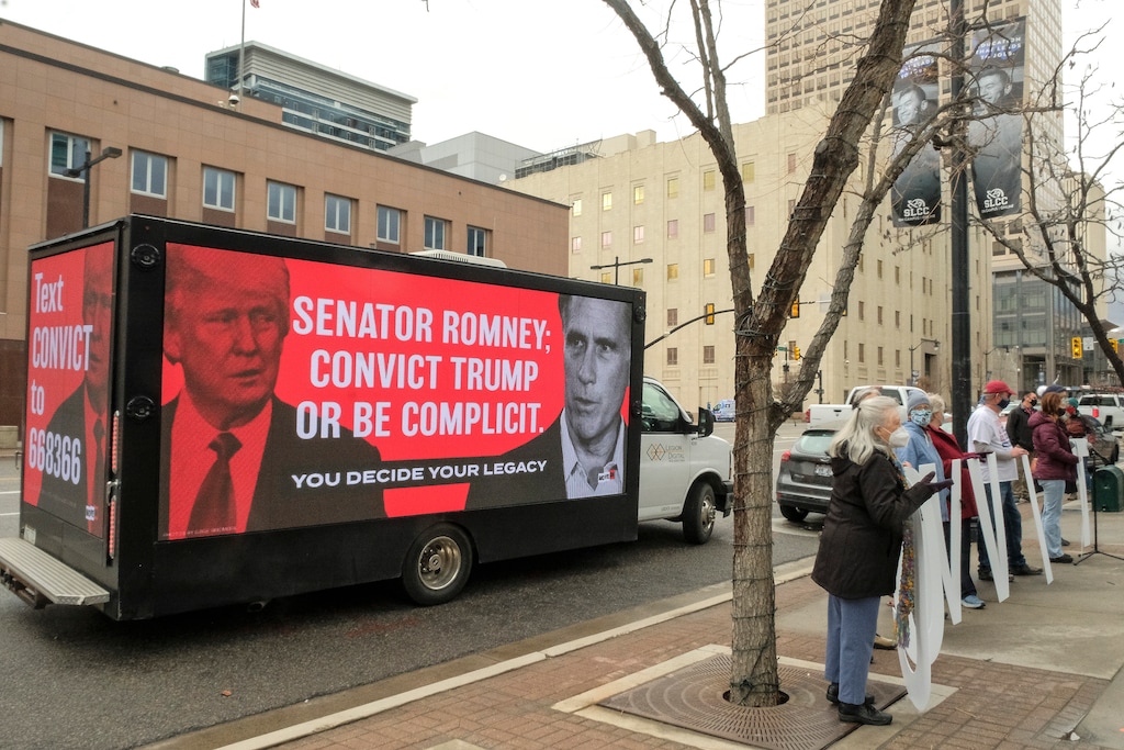 (Leah Hogsten | The Salt Lake Tribune) Members of Move-On staged a rally outside the Wallace F. Bennett Federal Building to encourage Sen. Mitt Romney to vote to impeach former President Donald Trump, Feb. 12, 2021. 