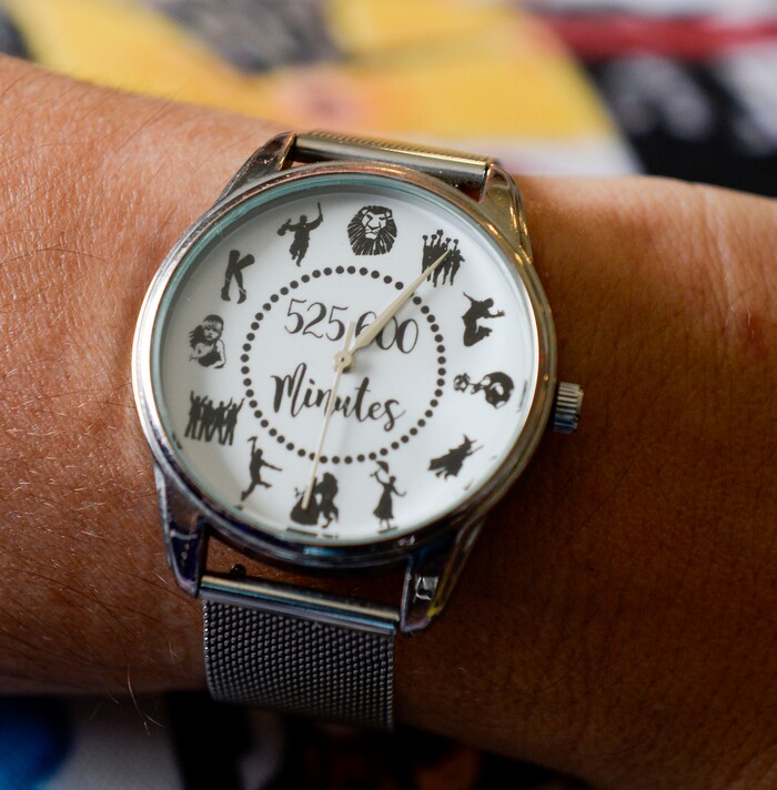 (Leah Hogsten  |  The Salt Lake Tribune) Megan Gutierrez shows off her watch with a lyric from a song in the theater production of Rent. In 1993, Megan Gutierrez fell in love with the theater after her parents took her to Les Miserables. Since then, Gutierrez has seen countless shows, collected memorabilia from them all and now leads Utah Theater Lovers and Theater Lovers Travel that takes theater lovers like herself across the U.S. and abroad to see the show.