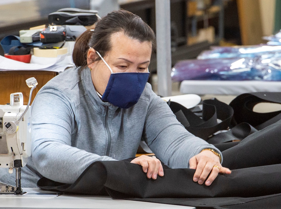 (Rick Egan  |  The Salt Lake Tribune)     Bata Barker wears one of the masks produced by her company, as she sews at SugarHouse Industries, which is making face masks and face shields, to protect against coronavirus, Thursday, March 26, 2020.
