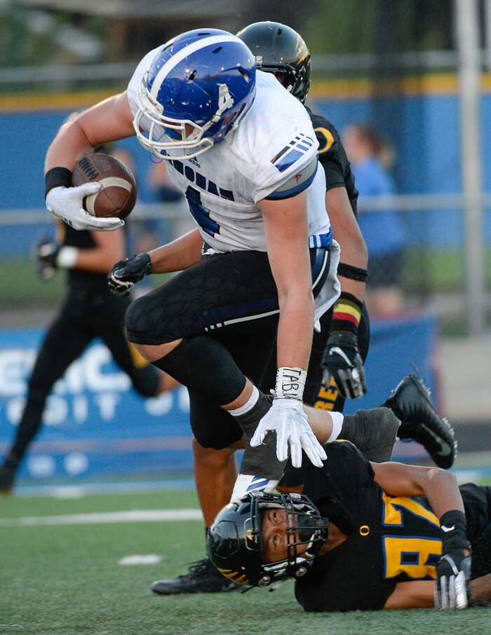 (Francisco Kjolseth  |  The Salt Lake Tribune)  Bingham's Briasen Harward runs over Orem's Jakob Robinson as he nears the end zone,  Thursday, Aug. 16, 2018 in Orem.