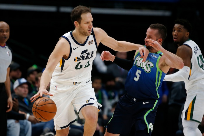 Utah Jazz forward Bojan Bogdanovic (44) tries to get away from Dallas Mavericks guard J.J. Barea (5) during the first half an NBA basketball game in Dallas, Monday, Feb. 10, 2020. (AP Photo/Michael Ainsworth)