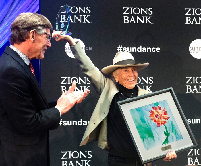 (Rick Egan  |  The Salt Lake Tribune)   Heidi Redd, a San Juan County conservationist, receives an award for her leadership, from Scott Anderson, president and CEO of Zions Bank, at the 2018 Sundance Film Festival Utah Women’s Leadership Celebration in Park City on Thursday, Jan. 25, 2018.
