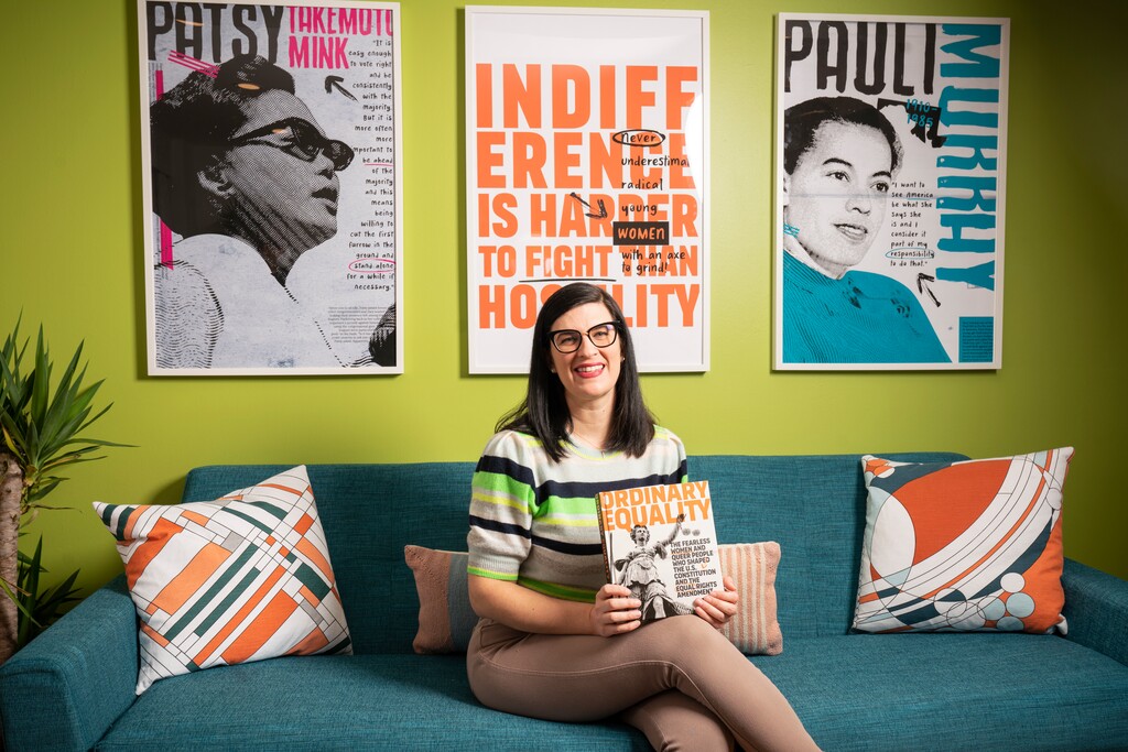(Xavi Dussaq/El País) Kate Kelly holds her new book, "Ordinary Equality," which will be released March 29. The book highlights women who fought for the Equal Rights Amendment.