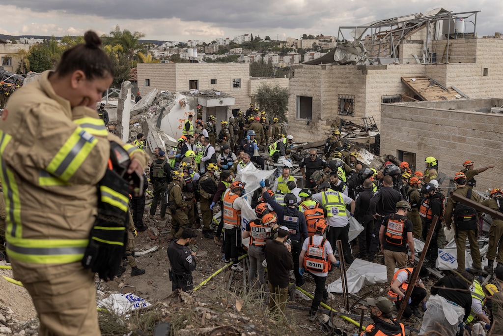 (Avishag Shaar-Yashuv | The New York Times) First responders at the scene where an Iranian ballistic missile hit in Beit Shemesh, Israel in March. Most U.S. Jews opposes the war.