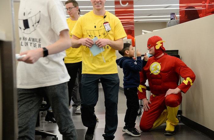 (Francisco Kjolseth  |  The Salt Lake Tribune) Max Warner, playing the role of "The Flash," gets an excited visit from a young patient before he gets no-cost dental care at the University of Utah on Saturday, Feb. 29, 2020. Warner was one of several superheroes and princesses volunteering to calm young people's nerves as part of a group called Service Opportunities 101, started by former U. graduate Marina McNeill.