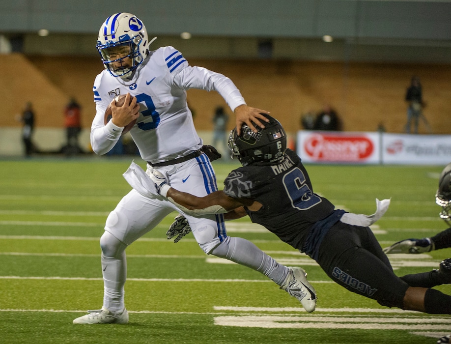 (Rick Egan  |  Tribune file photo) BYU quarterback Jaren Hall (3) tries to get past Utah State Aggies cornerback Cameron Haney (6), in football action between Brigham Young Cougars and Utah State Aggies in Logan on Saturday, Nov. 2, 2019.