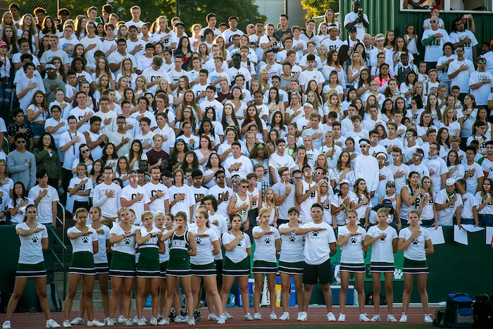 (Chris Detrick  |  The Salt Lake Tribune)    Hillcrest students listen to the National Anthem before the game at Hillcrest High School Friday, September 1, 2017. Cazzie Brown passed away Sunday night after spending four days in the hospital. According to a family representative, Brown was brought to the emergency room Wednesday for complications with his thyroid. The doctors found that he had contracted meningitis, and later received a preliminary positive after being tested for West Nile virus. 