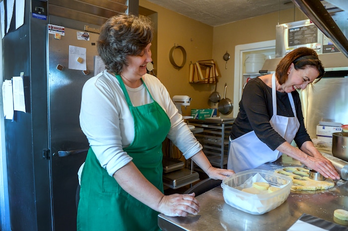 (Leah Hogsten  |  The Salt Lake Tribune) Owner Raelynn Potts, left, shares a laugh with Cathy Rogers, who punches out scones on her first day as assistant pastry chef at Auntie Rae's Dessert Island.