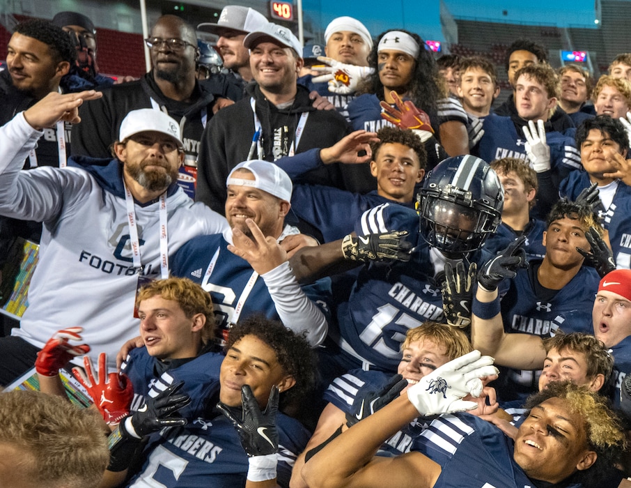 (Rick Egan | The Salt Lake Tribune) Corner Canyon head coach Eric Kjar, far left, celebrates with his team after winning the 6A football championship at Rice-Eccles Stadium on Nov. 20, 2025.