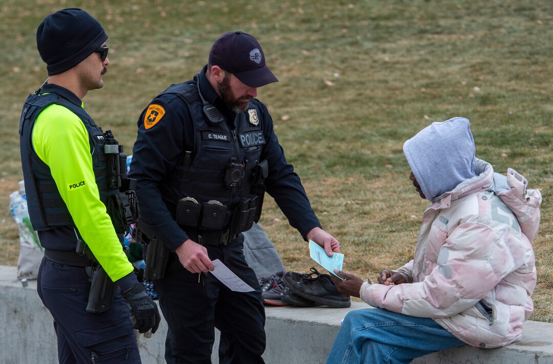 (Rick Egan | The Salt Lake Tribune) Salt Lake City Police give citations to a man near the Salt Lake City Library, Monday, Dec. 23, 2019.