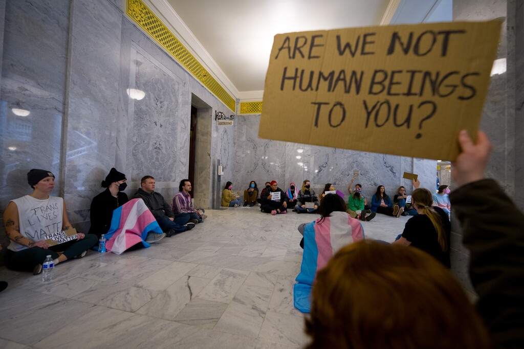 (Trent Nelson  |  The Salt Lake Tribune) Activists in support of transgender rights hold a sit-in in front of a bathroom at the Utah Capitol in Salt Lake City on Thursday, Feb. 22, 2024.