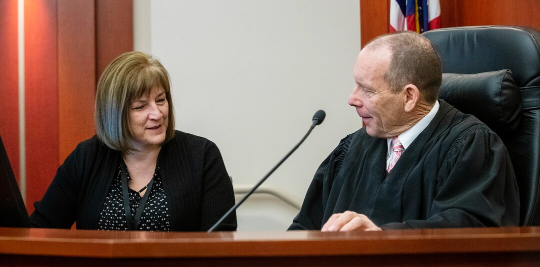 (Scott G Winterton  |  Deseret News/Pool) Juvenile Judge Renee Jiminez talks with Judge Paul B. Parker after they took care of their calendar on Friday, Dec. 13, 2019. Utah's juvenile judges will soon begin taking on cases in adult court, a move to help relieve crowded courtrooms in the state's most populated judicial district.