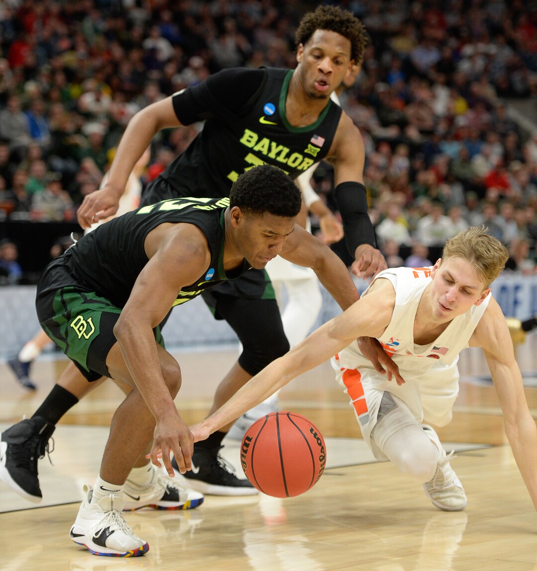 (Francisco Kjolseth  |  The Salt Lake Tribune)  Baylor Bears guard Jared Butler (12) and Syracuse Orange forward Marek Dolezaj (21) scramble for a ball as Syracuse faces Baylor in their first round menÕs NCAA March Madness tournament game at Vivint Smart Home Arena in Salt Lake City on Thursday, March 21, 2019.