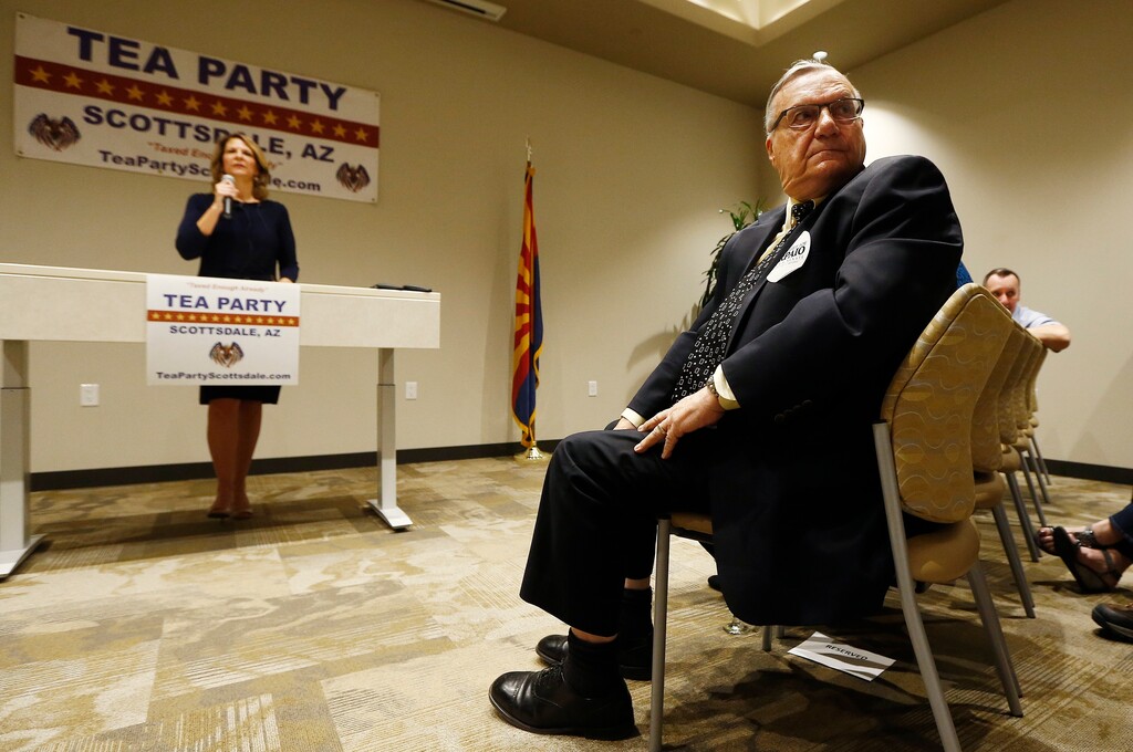 (Ross D. Franklin | The Associated Press) In this May 17, 2018, photo, Republican Senate candidates Kelli Ward, left, and former Maricopa Country Sheriff Joe Arpaio, right, listen to a question from the audience as the candidates talk about their platform policies at a Scottsdale Tea Party event in Scottsdale, Ariz. Arizona conservatives are torn between two icons of their movement — Arpaio and former state senator Ward — in the GOP Senate primary.