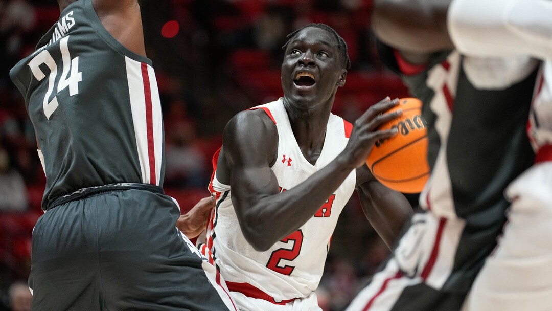 (Francisco Kjolseth | The Salt Lake Tribune) Utah Utes guard Both Gach (2) faces stiff defense from the Washington State Cougars  in game action at the Jon M.Huntsman Center, on Saturday, Jan. 8, 2022. Utah lost 61-77.
