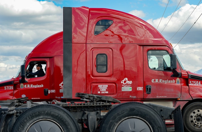 (Francisco Kjolseth | The Salt Lake Tribune) Truck drivers come and go at C.R. England trucking in Salt Lake City on Monday, March 30, 2020. The coronavirus outbreak has helped make truckers heroes as they help to stock empty shelves in stores. Drivers face new challenges from finding restrooms and food on the road amid shutdowns, but say they enjoy driving with no congestion.