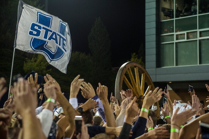 (Chris Detrick  |  The Salt Lake Tribune)  Utah State Aggies  football players and students celebrate with the Old Wagon Wheel after the game at Merlin Olsen Field at Maverik Stadium Friday, September 29, 2017. Utah State Aggies defeated Brigham Young Cougars 40-24.