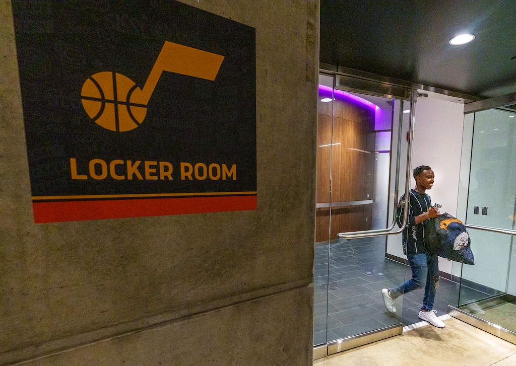 (Leah Hogsten | The Salt Lake Tribune) Soni Imanizabayo, 18, of South Jordan is all smiles as he walks out of the Jazz locker room with a bag of clothing intended for Jazz basketball player Donovan Mitchell on Thursday. The Utah Jazz rewarded 17 local kids who are making an impact in the community with a Jazz locker room raid at Vivint Arena,Thursday, June 30, 2022. Each winner was nominated by a family member, peer or friend for their exemplary behavior, giving back to the community and showcasing kindness and inclusivity.