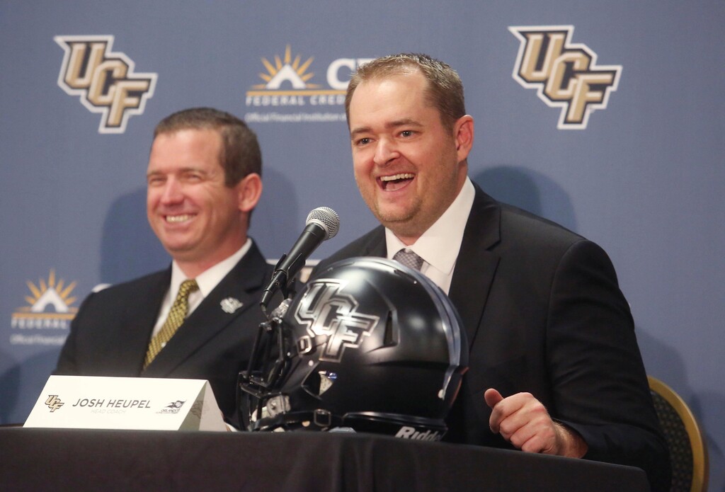 Josh Heupel, right, is introduced as the new Central Florida head football coach by Danny White, UCF Athletic director in Orlando, Fla., Tuesday, Dec. 5, 2017. Heupel has been the offensive coordinator at Missouri the past two seasons. He replaces Scott Frost, who accepted the Nebraska coaching job after leading UCF to a 12-0 record and the American Athletic Conference title. (Red Huber/Orlando Sentinel via AP)