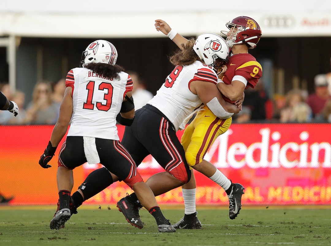 Southern California quarterback Kedon Slovis (9) is hit by by Utah defensive tackle Leki Fotu during the first half of an NCAA college football game Friday, Sept. 20, 2019, in Los Angeles. (AP Photo/Marcio Jose Sanchez)