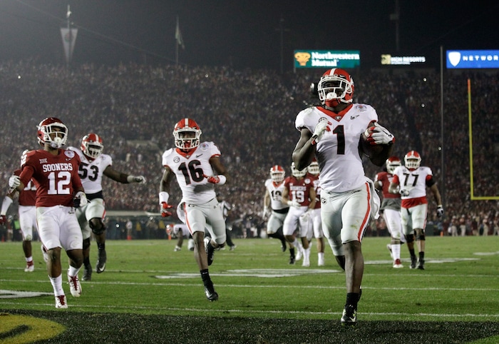 Georgia running back Sony Michel (1) scores a touchdown in overtime against Oklahoma in the Rose Bowl NCAA college football game, Monday, Jan. 1, 2018, in Pasadena, Calif. Georgia won 54-48. (AP Photo/Jae C. Hong)