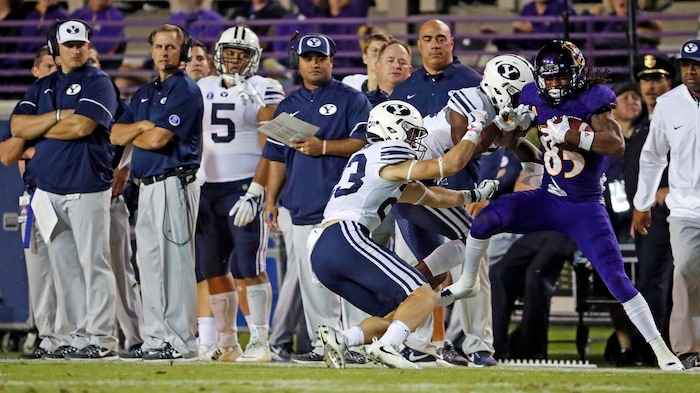East Carolina's Davon Grayson (85) hauls in a pass in front of BYU's Trevion Greene (12) and Zayne Anderson (23) during the second half of an NCAA college football game in Greenville, N.C., Saturday, Oct. 21, 2017. (AP Photo/Karl B DeBlaker)