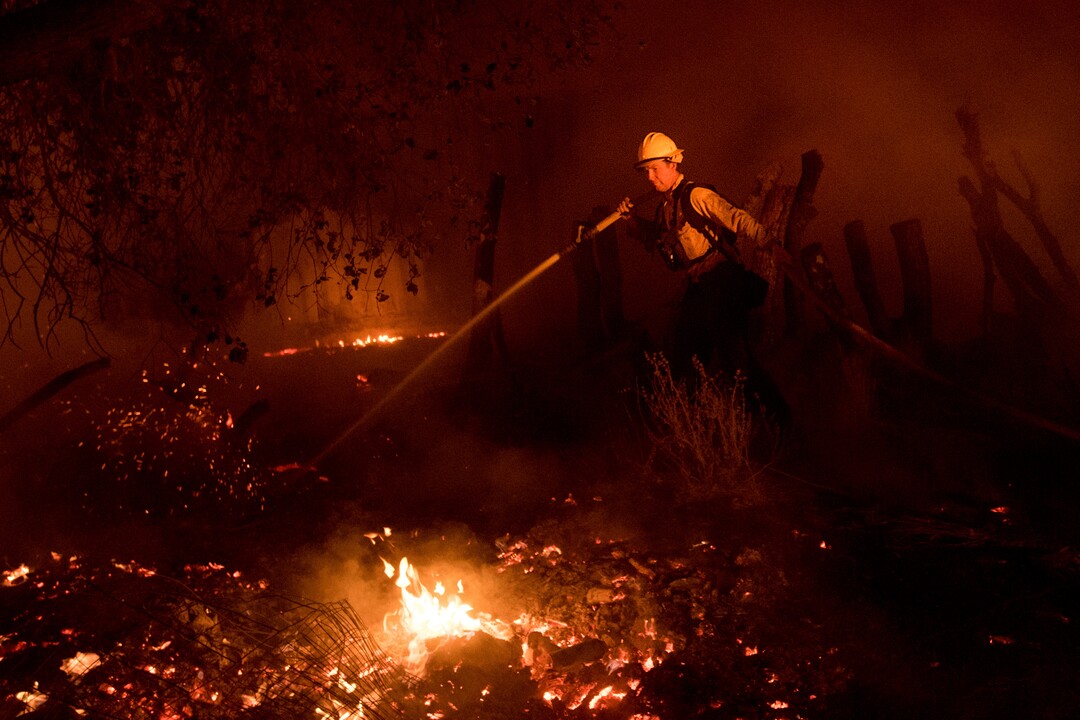 A firefighter battles a wildfire in Ojai, Calif., on Thursday, Dec. 7, 2017. (AP Photo/Noah Berger)