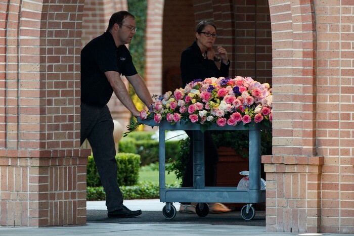 Flowers are wheeled into St. Martin's Episcopal church for the funeral of former first lady Barbara Bush, Saturday, April 21, 2018, in Houston. (AP Photo/Evan Vucci)
