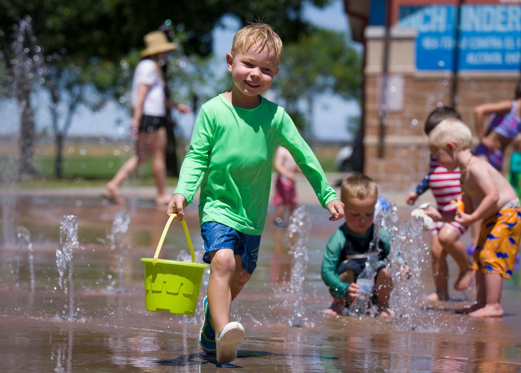 (Bethany Baker  |  The Salt Lake Tribune) Henry Miller plays at the splash pad at Legacy Park in North Salt Lake on Thursday, July 9, 2026.