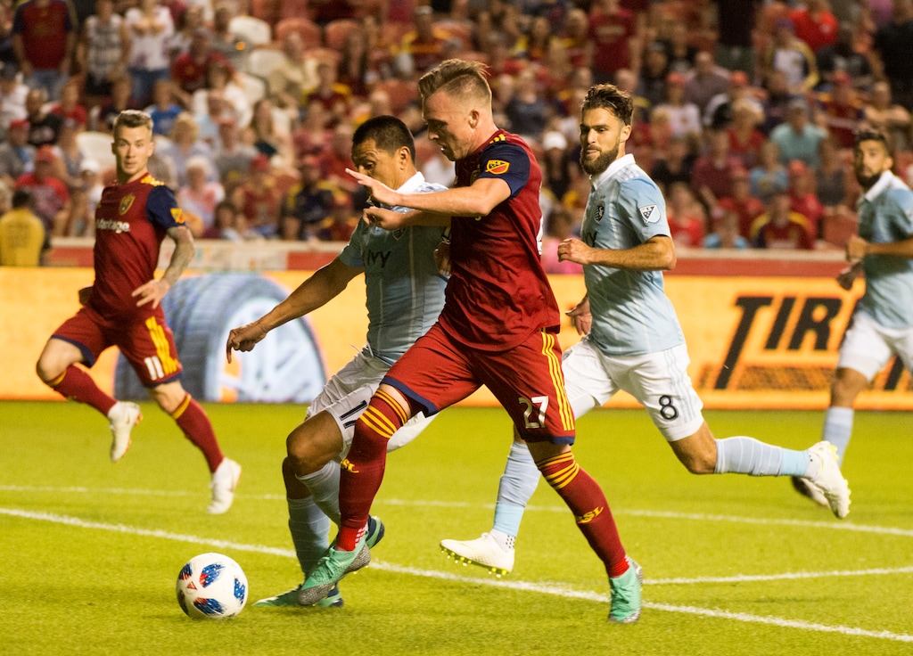 (Rick Egan  |  The Salt Lake Tribune)      Real Salt Lake forward Corey Baird (27) races down field ahead of Sporting Kansas City midfielder Roger Espinoza (17) in MLS soccer action between Real Salt Lake and Sporting Kansas City at Rio Tinto Stadium, Wednesday, July 4, 2018.