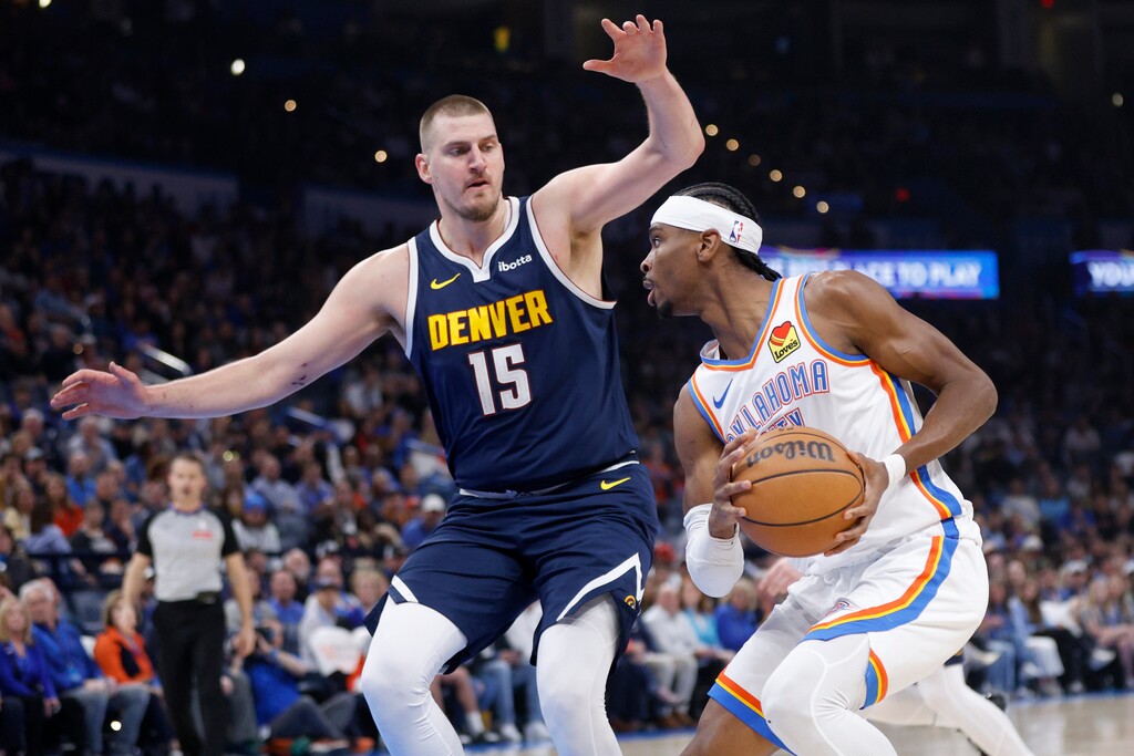 Oklahoma City Thunder guard Shai Gilgeous-Alexander, right, drives against Denver Nuggets center Nikola Jokic (15) during the first half of an NBA basketball game Monday, March 10, 2025, in Oklahoma City. (AP Photo/Nate Billings)
