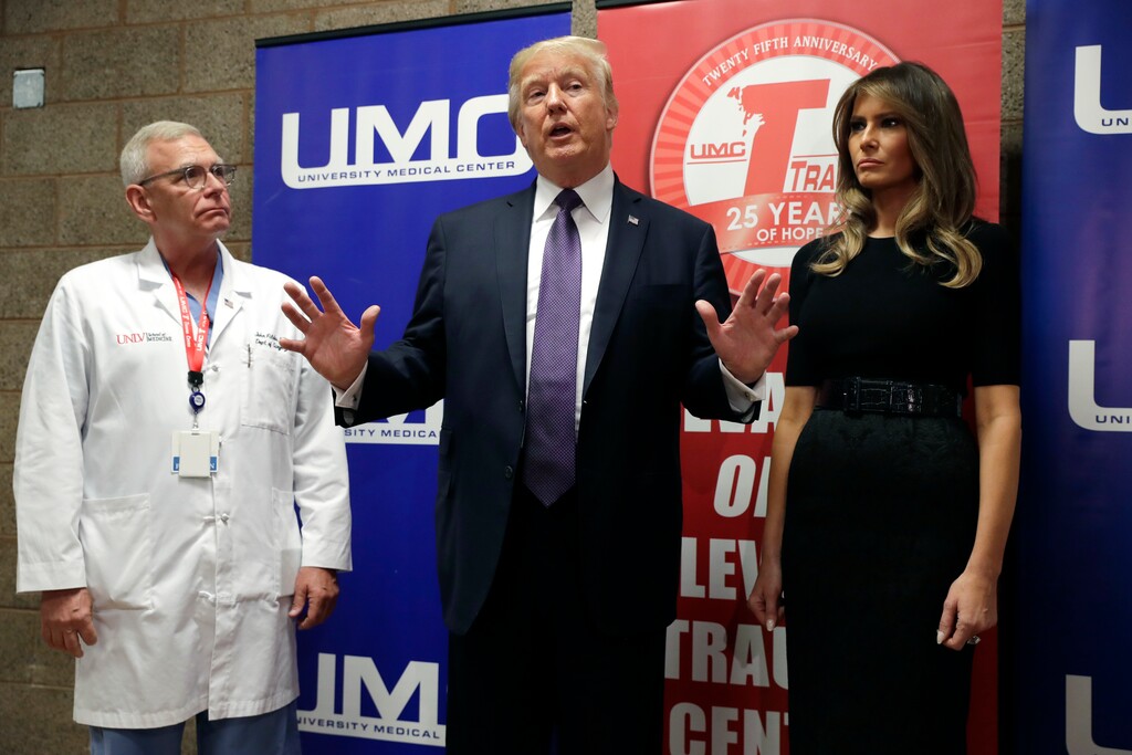 President Donald Trump talks as first lady Melania Trump and surgeon Dr. John Fildes listens at the University Medical Center after Trump met with survivors of the mass shooting Wednesday, Oct. 4, 2017, in Las Vegas. (AP Photo/Evan Vucci)